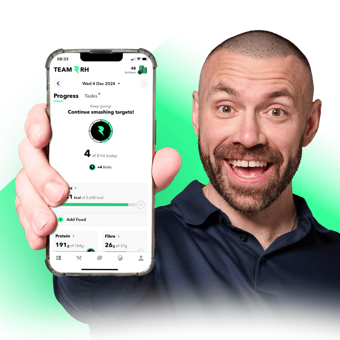 Richie Howie holding a phone showing the Team RH app
